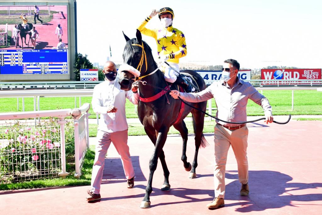 The horse WOKONDA being led in at Turffontein by trainer Sean Tarry.